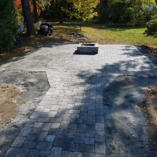 a pathway with a fireplace backyard
